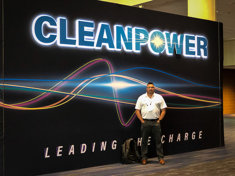 L&L Concrete Project Manager & Estimator, Manny Esteves, outside the entrance to the Cleanpower 2023 expo at the Morial Convention Center in New Orleans.