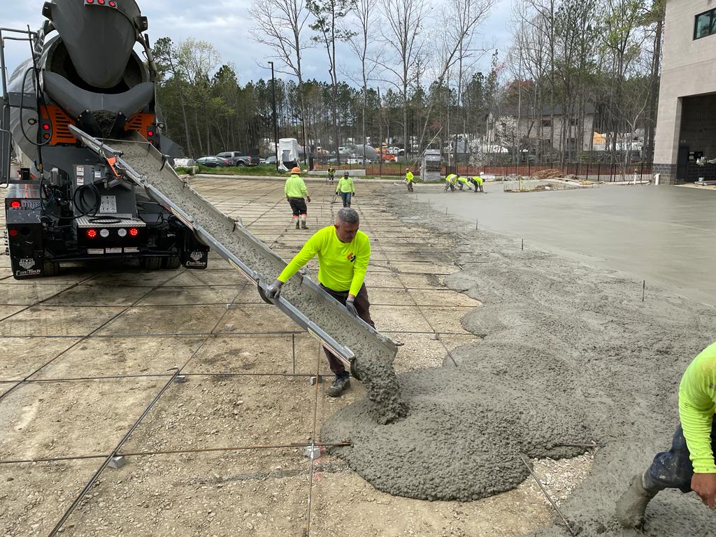 L&L Concrete workers pour concrete during construction of a concrete parking lot in Morrisville, NC.