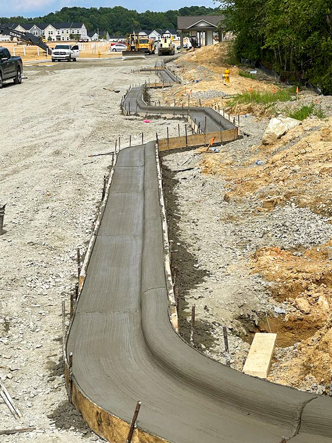 New concrete curb and gutter installation, constructed by L&L Concrete near Raleigh, NC.