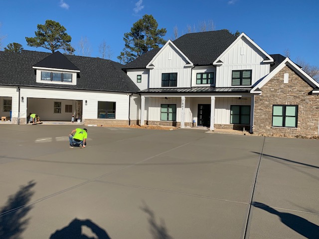 A beautiful new concrete driveway under construction at a luxury home near Raleigh, NC.