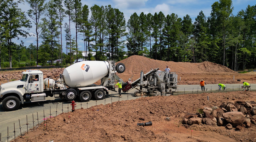 A curb & gutter machine crew from L&L Concrete, at work building a curb & gutter near Raleigh, NC.