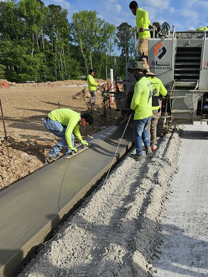 A curb machine crew from L&L Concrete, at work with their Power Curbers 5700-C machine.